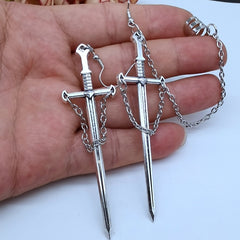 Grunge style earrings with a sword