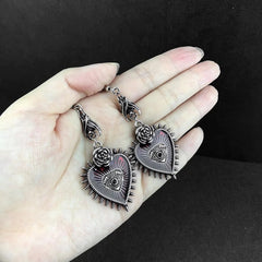 Dangling earrings with red heart in gothic style